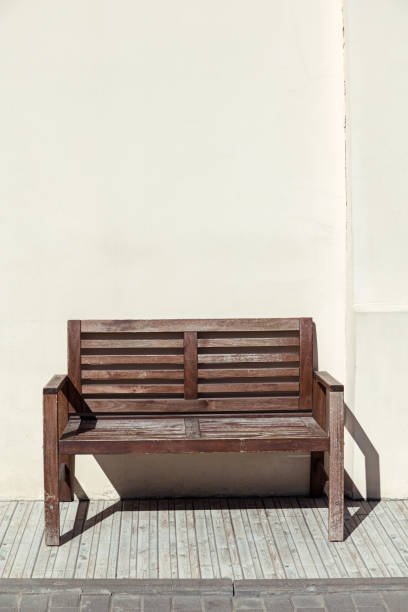 istock street wooden bench near old wall 955765384