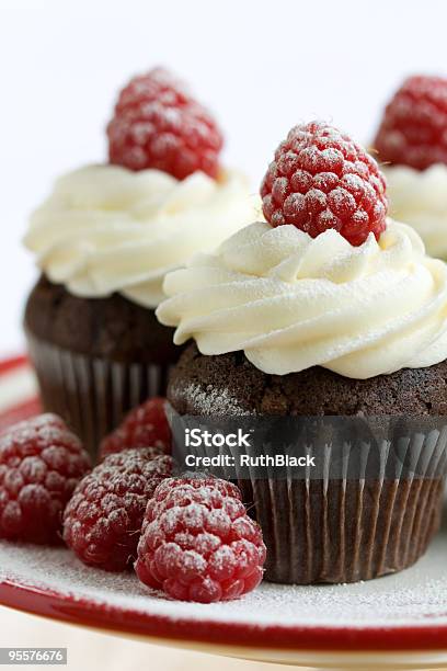 Chocolate And Raspberry Cupcakes Served On A Plate Stock Photo - Download Image Now - Cupcake, Baked, Berry Fruit