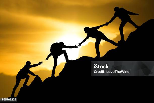 Group Of People On Peak Mountain Climbing Helping Team Work Travel Trekking Success Business Concept Stock Photo - Download Image Now