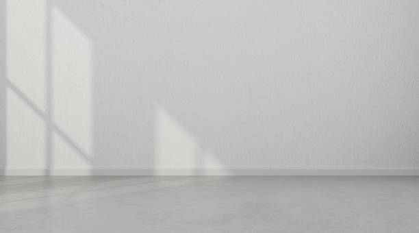 istock 3D stimulate of white room interior and concrete floor with sun light cast the shadow on the wall,Perspective of minimal design architecture 955771034