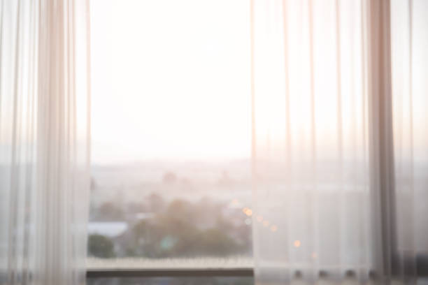 Defocused curtain window with sunlight in the early morning. For montage product display or design key visual layout