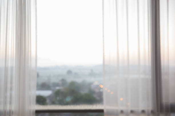 istock Defocused curtain window with sunlight in the early morning. 955772064
