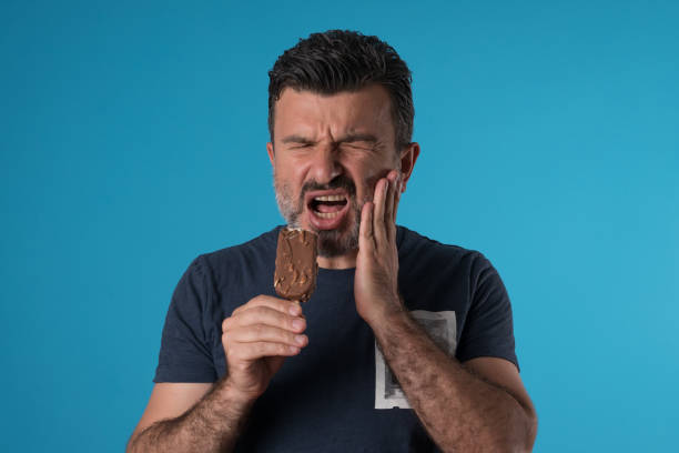 Mid adult man experiencing tooth ache