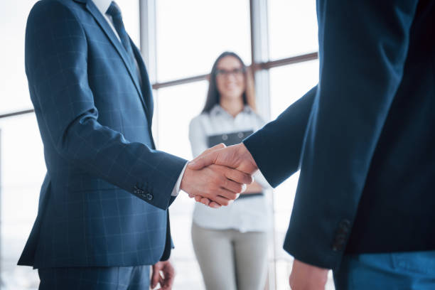 istock Two confident business man shaking hands during a meeting in the office, success, dealing, greeting and partner concept 955776176