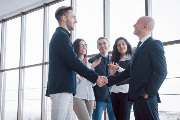 istock Two confident business man shaking hands during a meeting in the office, success, dealing, greeting and partner concept 955776950