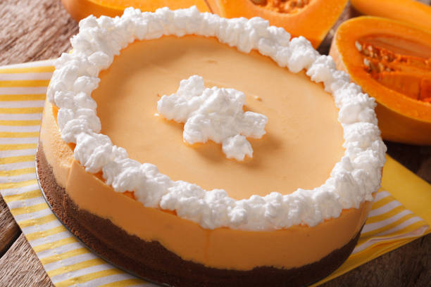 istock Tasty pumpkin cheesecake with whipped cream close-up. horizontal 955777748