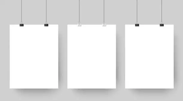 Vector illustration of Empty affiche mockup hanging on paper clips. White blank advertising poster template casts shadow on gray background vector illustration