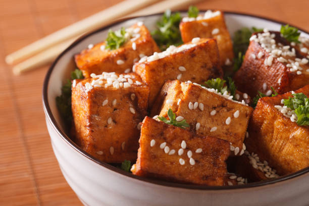 istock fried crispy tofu with sesame in a bowl close-up. horizontal 955787612