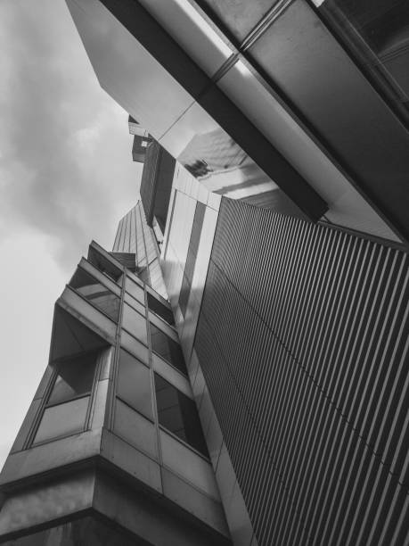 istock Black and white abstract upward view of a downtown skyscraper. 955788070