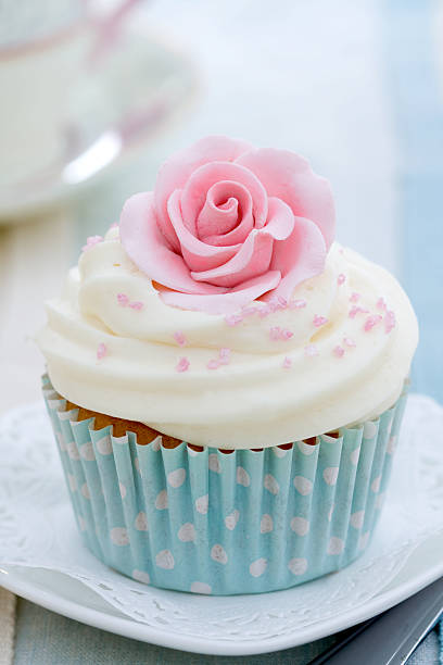 istock Smooth textured buttercream cupcake with edible rose on top 95578952