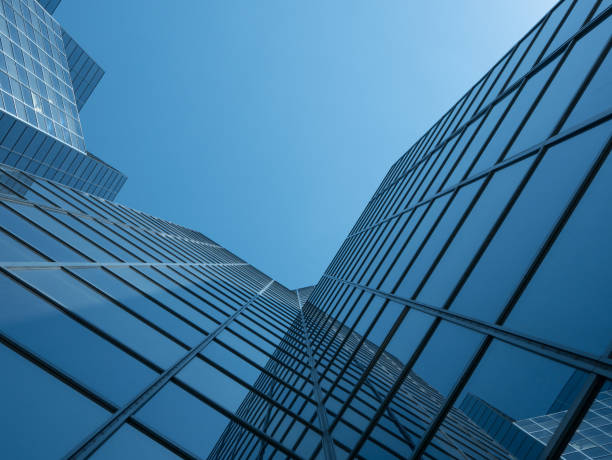 istock Angle view of modern building with a clear blue sky in background 955789882