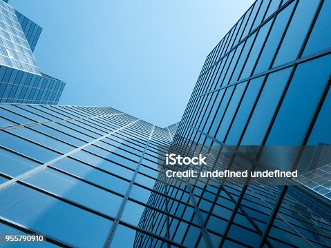 istock Angle view of modern building with a clear blue sky in background 955790910
