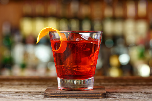 Classic cocktail Negroni with gin, campari and martini rosso. Traditional recipe. Place for writing text