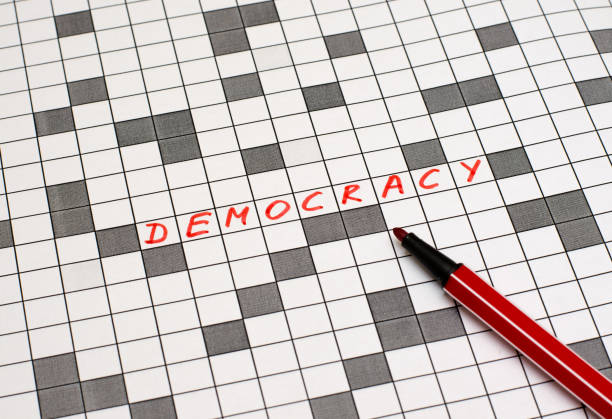 istock Democracy. Text in crossword. Red letters. Close-up 955792196