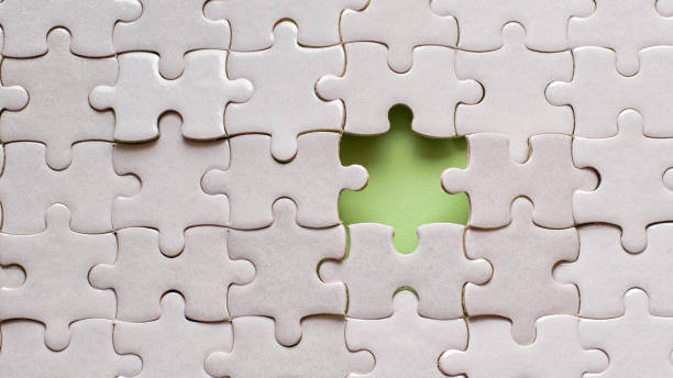 istock White details of puzzle on green background 955795694