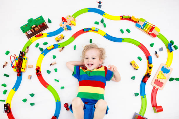 istock Child with toy train. Kids wooden railway. 955796580