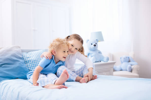 istock Kids playing in white bedroom 955796676