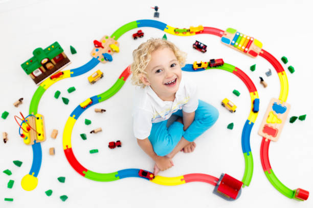istock Child with toy train. Kids wooden railway. 955796828