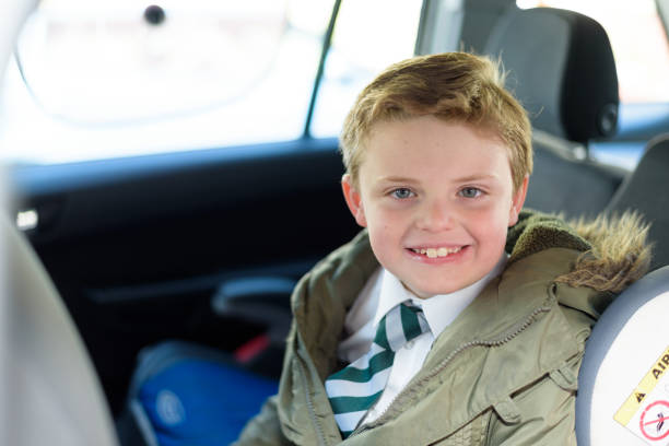 istock Schoolboy sat in car seat, ready to go back to school 955796964