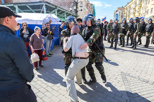 Samara, Russia - May 5, 2018: Protester is arrested by police at the opposition rally ahead of President Vladimir Putin's inauguration ceremony