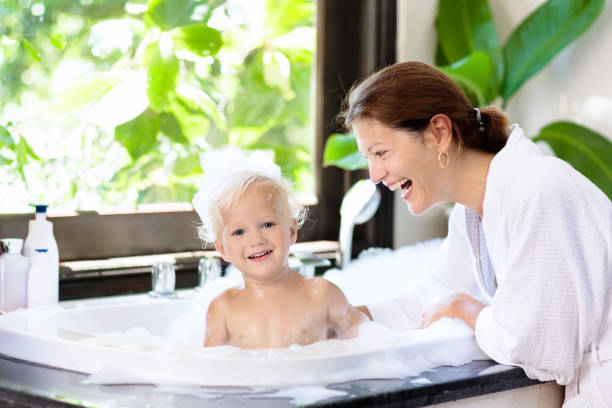 istock Mother washing baby in bubble bath. Water fun. 955799718