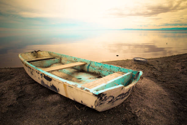 abandoned row boat along shore on Salton Sea in the California Desert