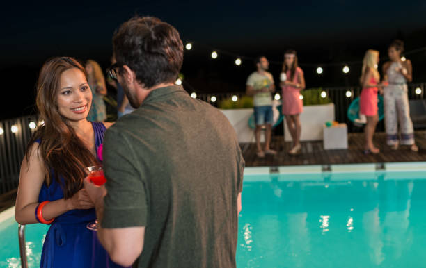 istock Friends Enjoying Pool Party 955807822