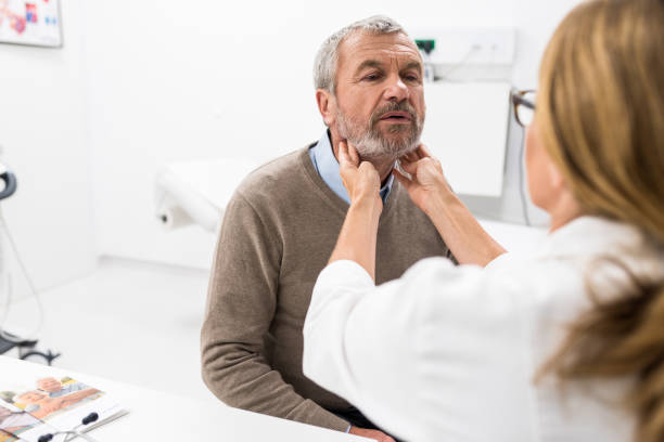 istock Female Doctor Doing Throat Examination On Older Man 955808530