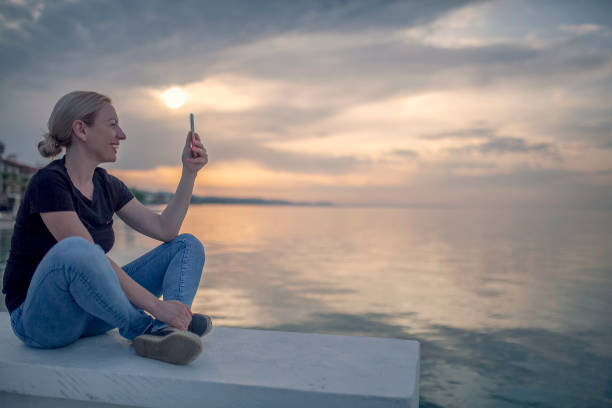 istock Young woman enjoying by the sea 955808792