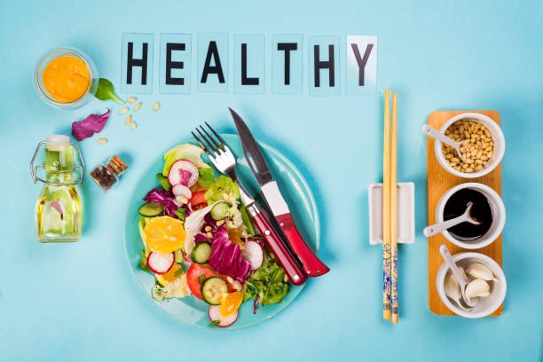 istock Healthy eating concept with fresh vegetables and salad bowls on kitchen wstone worktop, 955808814