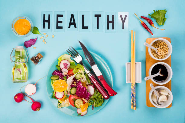 istock Healthy eating concept with fresh vegetables and salad bowls on kitchen wstone worktop, 955808876