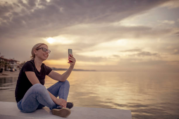 istock Young woman enjoying by the sea 955808922