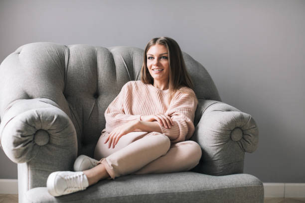 istock Woman sitting on comfortable chair at home. 955809214
