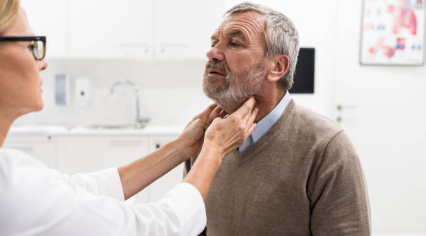istock Female Doctor Doing Throat Examination On Older Man 955809390