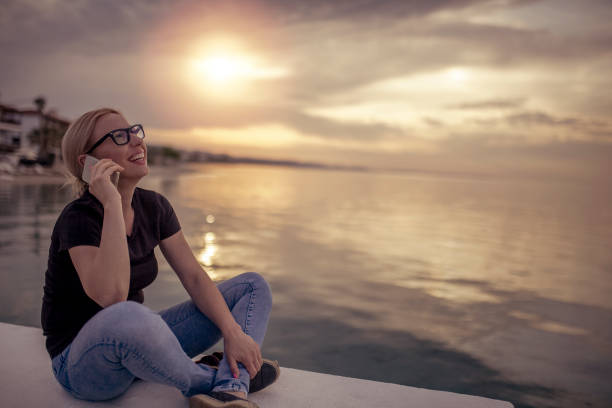 istock Young woman enjoying by the sea 955809984