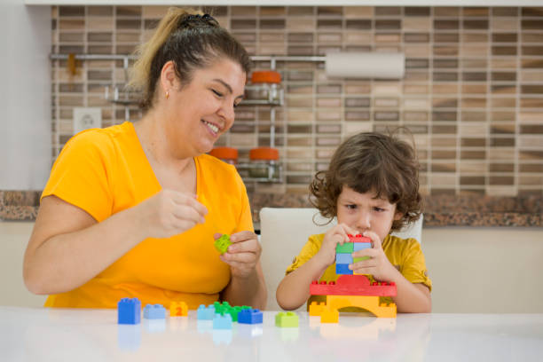 istock Mother and child playing with Preschoolers Building Blocks 955812582