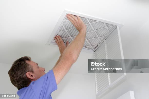 Inserting New Air Filter In Ceiling Stock Photo - Download Image Now - Filtration, Air Purifier, Furnace