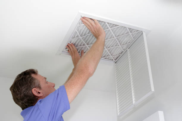 inserting new air filter in ceiling - domestic issues imagens e fotografias de stock