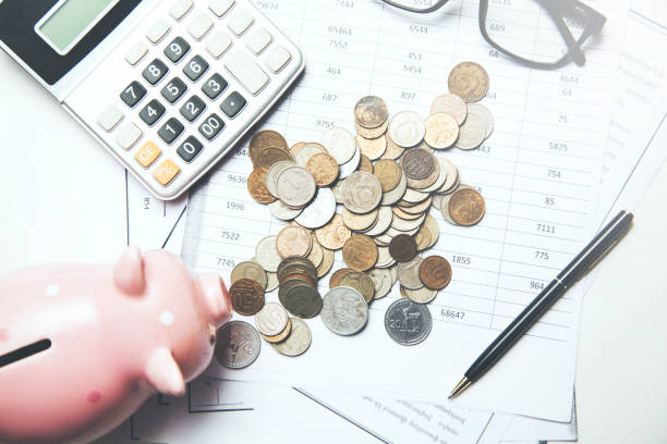 istock coins with piggy  bank and calculator on document 955827862