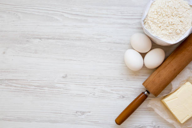 istock Ingredients for dough preparation on white wooden background. Copy space. Flat lay. Top view. 955833990