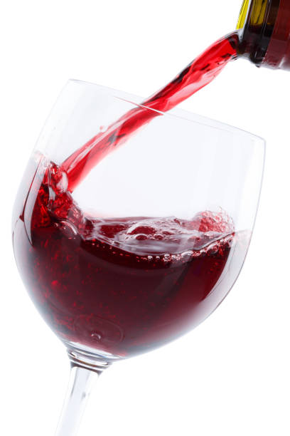 istock Wine pouring glass bottle red pour portrait format isolated 955834052
