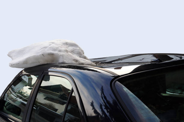 istock A roof avalanche damaged a black car on the roof 955839904