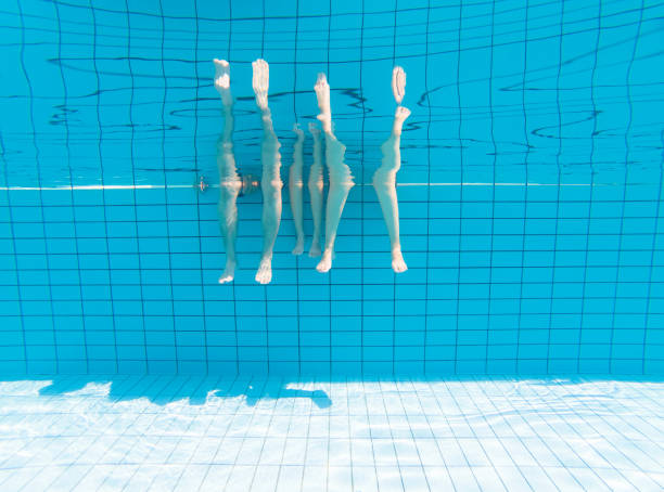 istock family feet under water in swimming pool 955844966