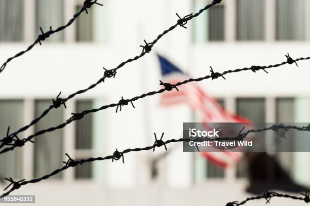 Barbed Wire In The Foreground And The Blurred American Flag In The Background Manhattan New York City Usa Stock Photo - Download Image Now
