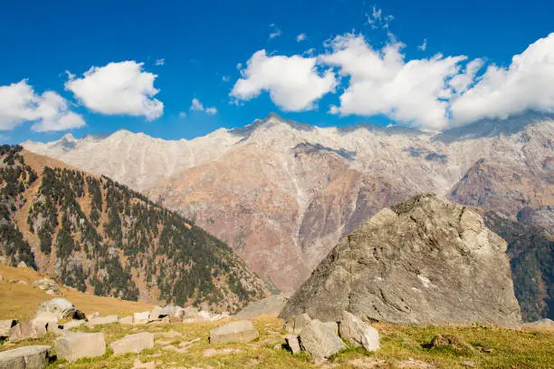 A beautiful view of Dhauladhar Mountain ranges during a sunny day and some clouds. Triund, Himachal Pradesh. India