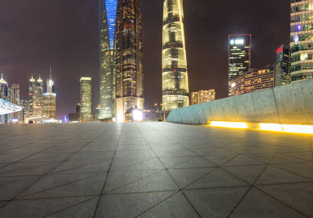 istock empty square floor and city skyline scene in shanghai at night 955860878
