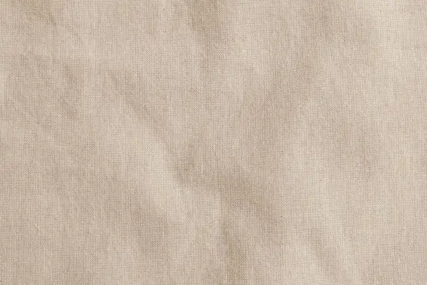 Photo of Hessian sackcloth woven fabric texture background in beige cream brown color