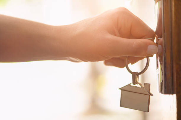istock Woman using a house key on the front door. 955864408