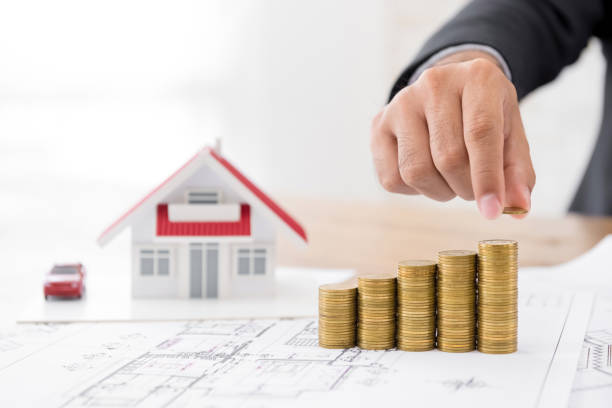 istock Real-estate investor projecting profit growth of housing development plan using coins 955864846