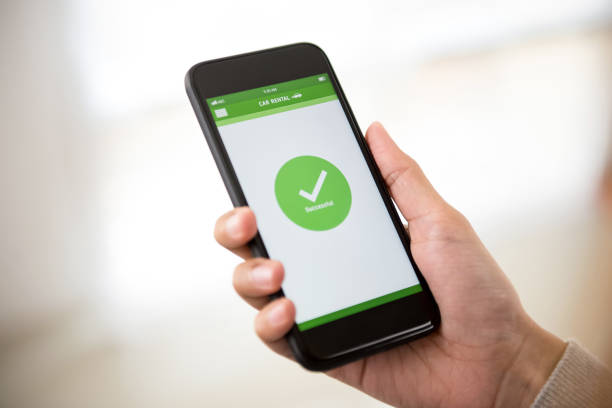 istock Woman completing car rental booking on smartphone 955864880